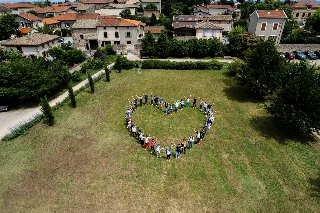 Creative aerial group photo in heart shape - drone event photography